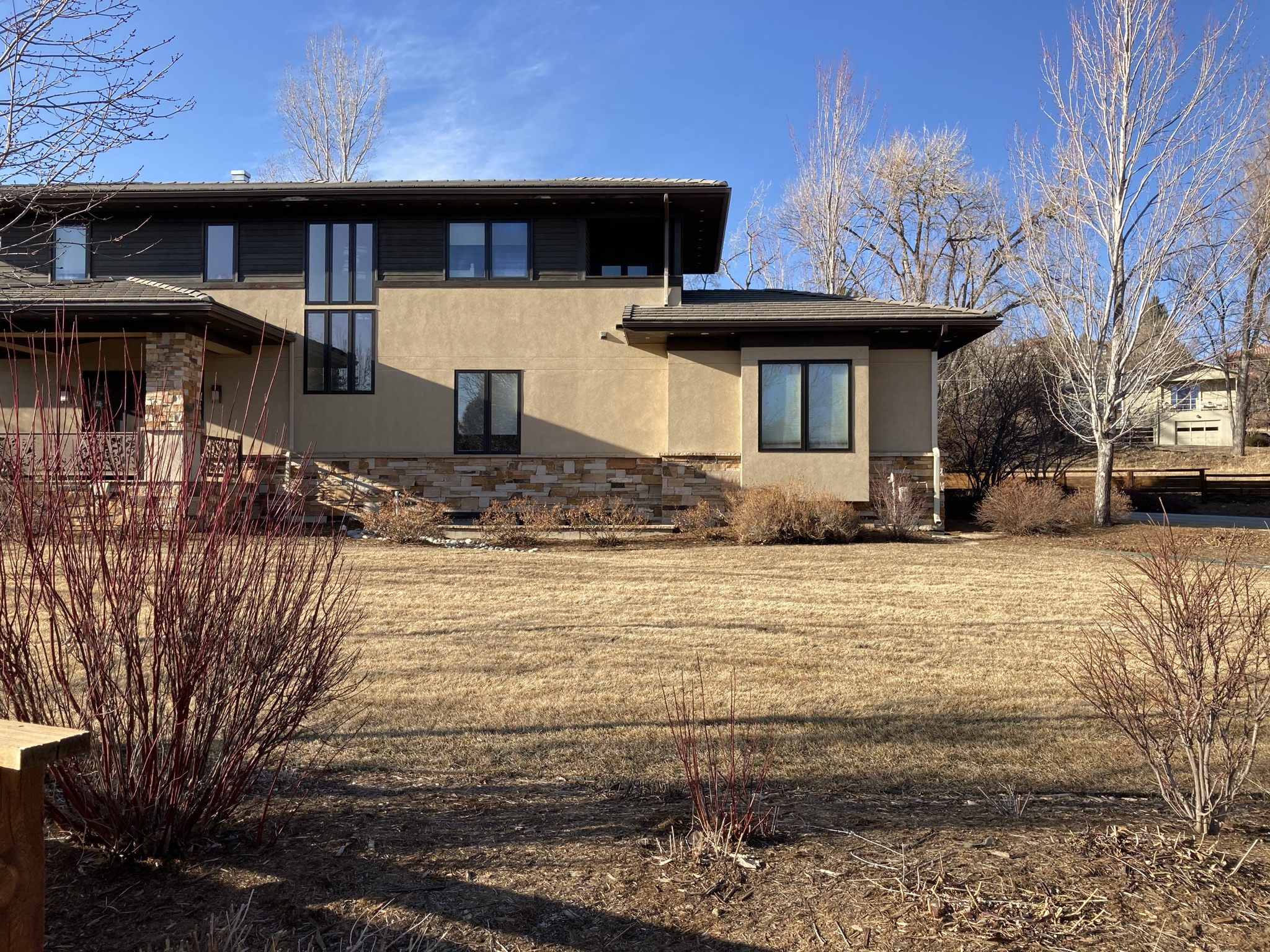 Rear exterior of Parkside Villa before renovation, illustrating the original relationship between the home and backyard before the redesign.