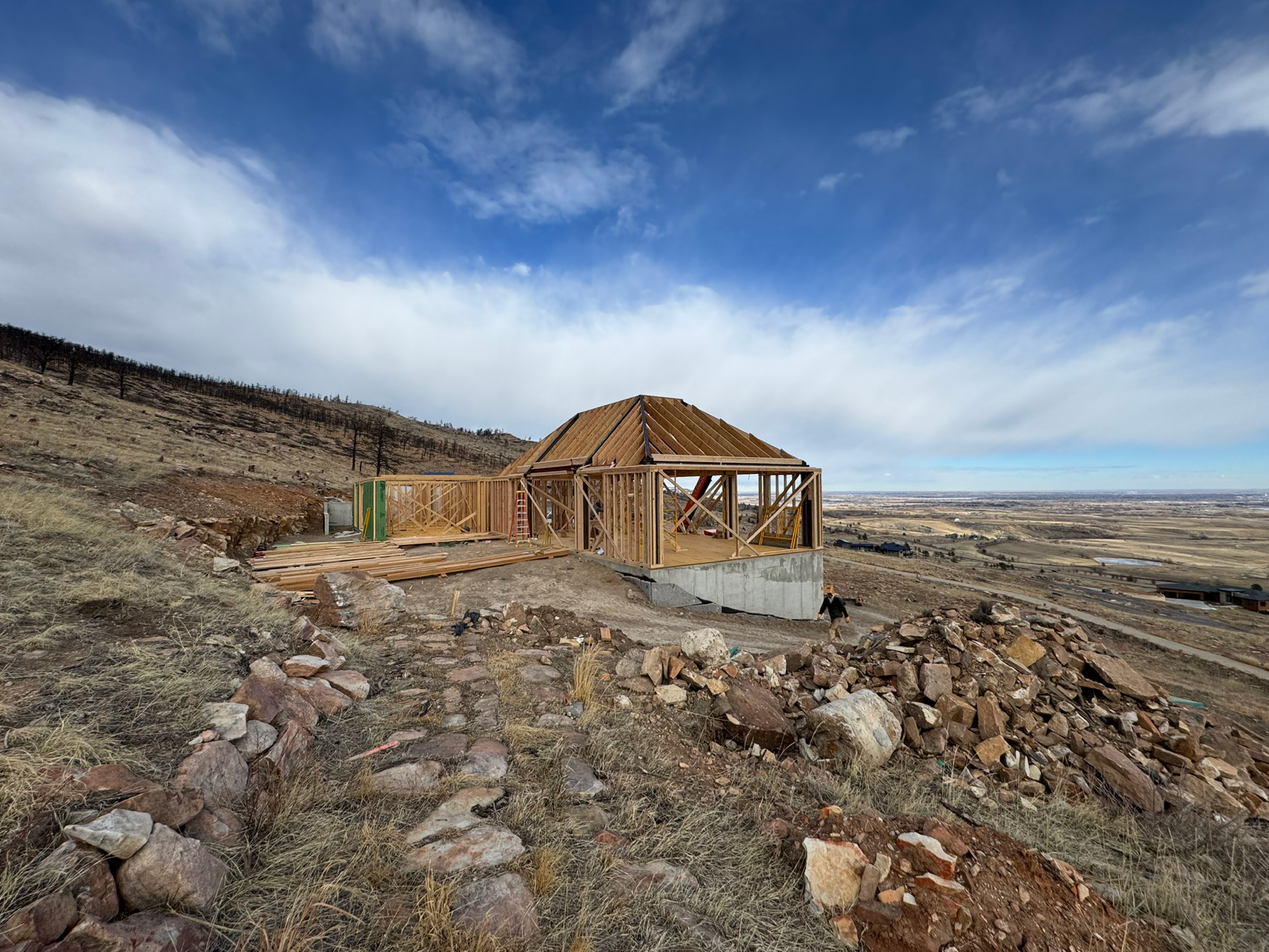 Wood framing of a modern home under construction on a hillside site