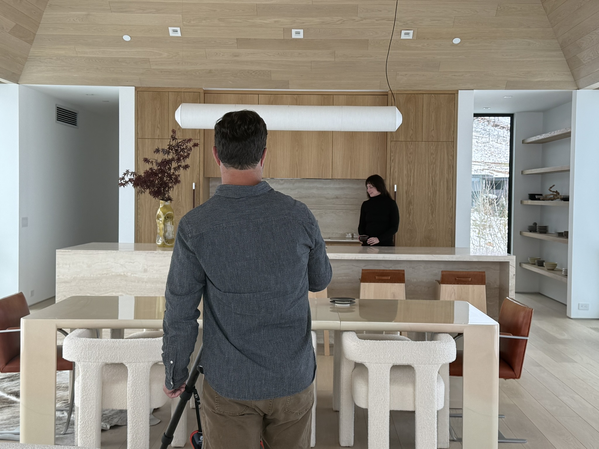 Behind-the-scenes view of photographer James Florio capturing the kitchen and living spaces at Mountain Ridge during a winter architectural photoshoot.