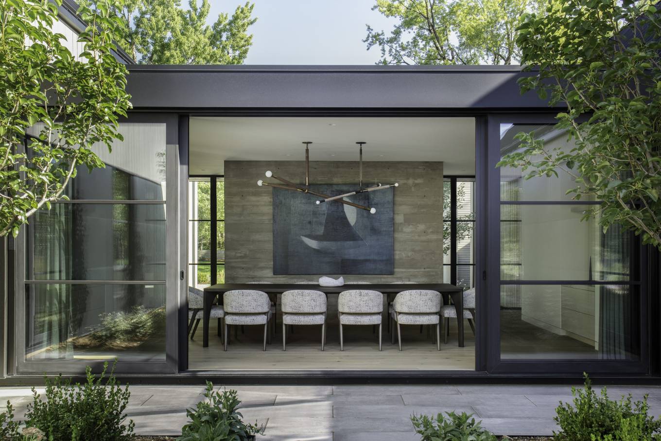 The interior of the Linden Grove residence is a rich compilation of materials such as blackened steel, board-formed concrete, marble, and white oak.