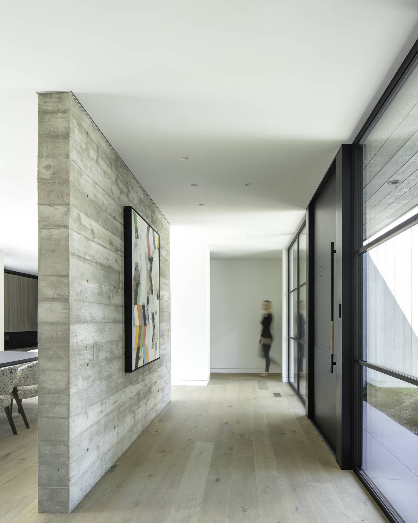 The interior of the Linden Grove residence is a rich compilation of materials such as blackened steel, board-formed concrete, marble, and white oak.