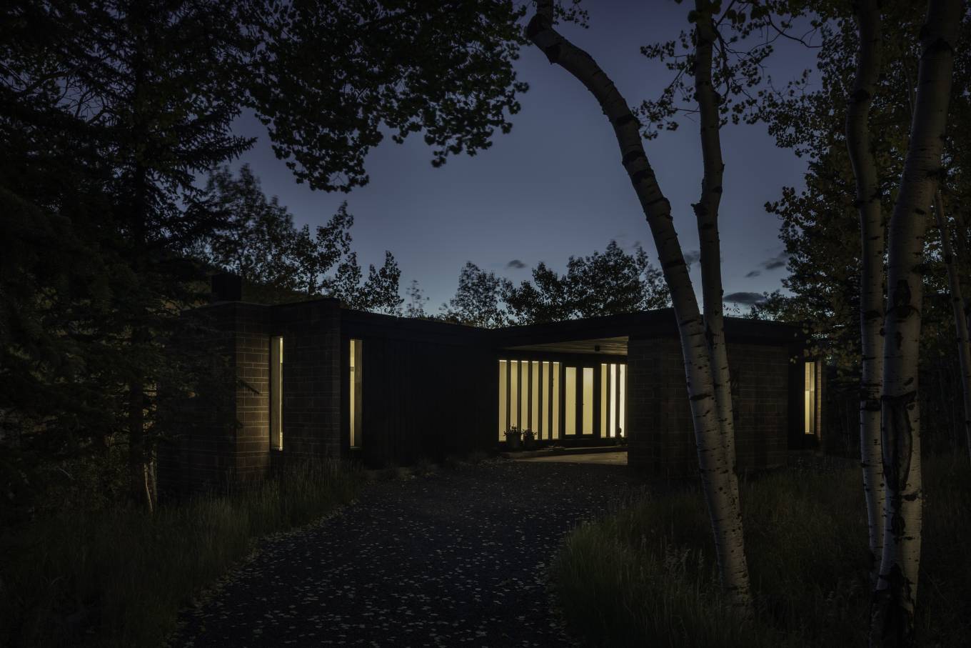 Originally constructed in 1968, this modest mid-century house was completely renovated and thrives in its surrounding aspen forest on a sloping hillside while enjoying the seasonal changes within its high-alpine landscape.