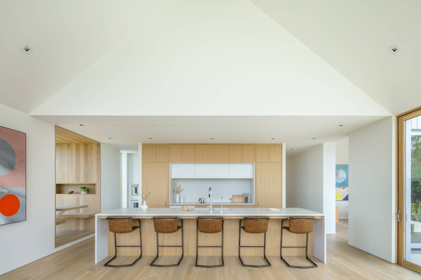 The expressive, folded roof forms are playful, and varied yielding assortment of light filled spaces that are both intimate and cozy as well as expansive and voluminous.