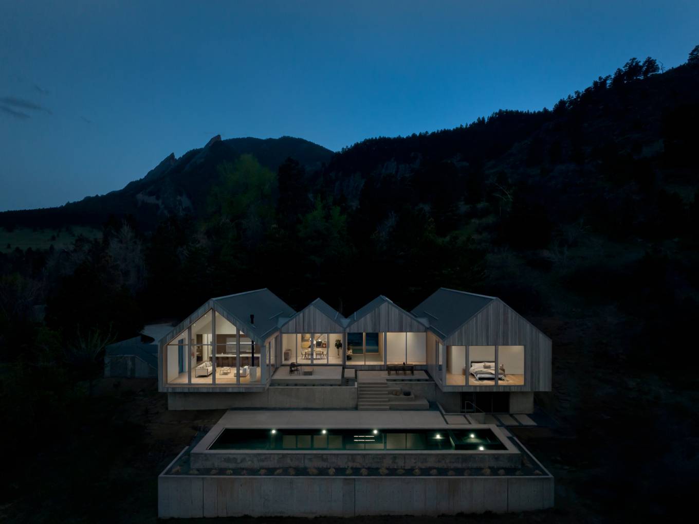 Villa H harmoniously integrates in a rugged, dramatic Alpine context.